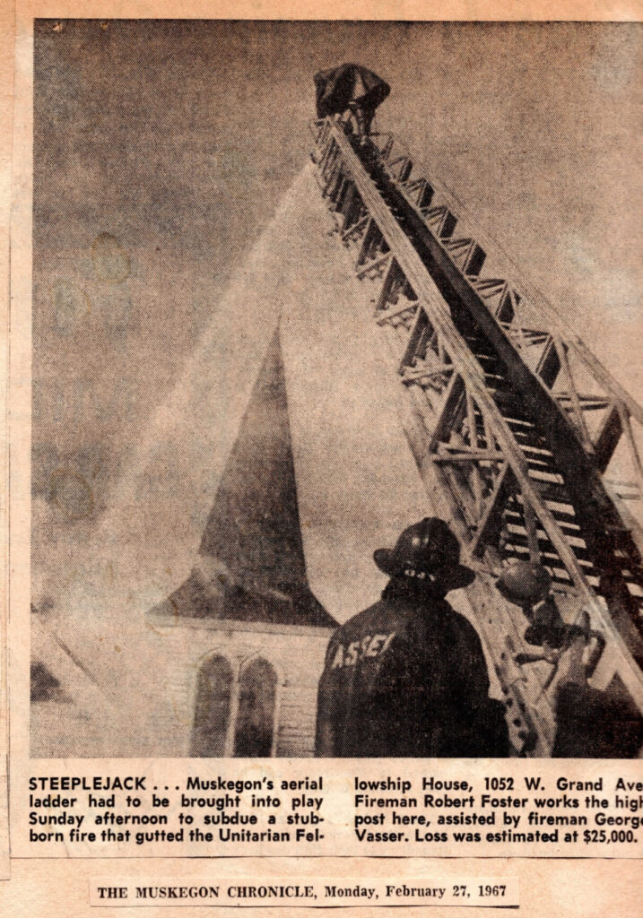 A newspaper clipping showing the fire truck ladder and hose extended to reach the steeple of the church.